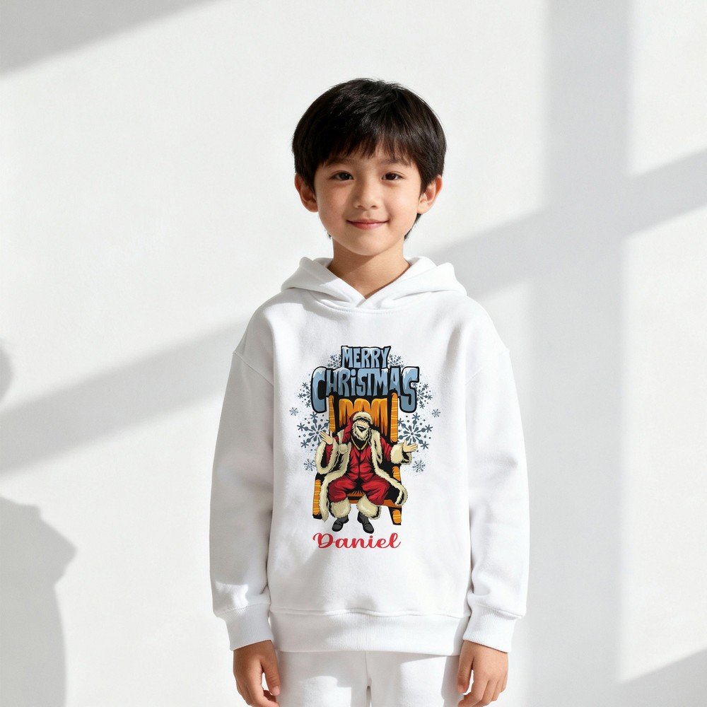Kid wearing a white Christmas hoodie with Santa illustration and ‘Merry Christmas’ text, festive holiday design, also available in red, black, and grey.