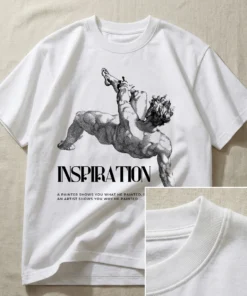 Flatlay of an oversized white T-shirt displaying the inspirational artist quote design