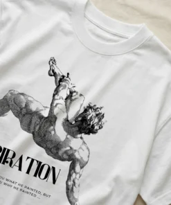 Flatlay of an oversized white T-shirt showing a close-up of the inspirational artist quote design.