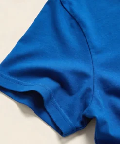 Close-up photo of a royal blue unisex t-shirt showing the fabric texture, stitching, and true color.