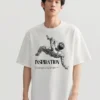 Model wearing an oversized white T-shirt featuring an inspirational artist quote design.