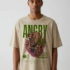 Model wearing a beige oversized streetwear T-shirt featuring a bold bear graphic design.