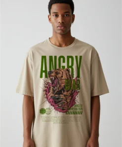 Model wearing a beige oversized streetwear T-shirt featuring a bold bear graphic design.