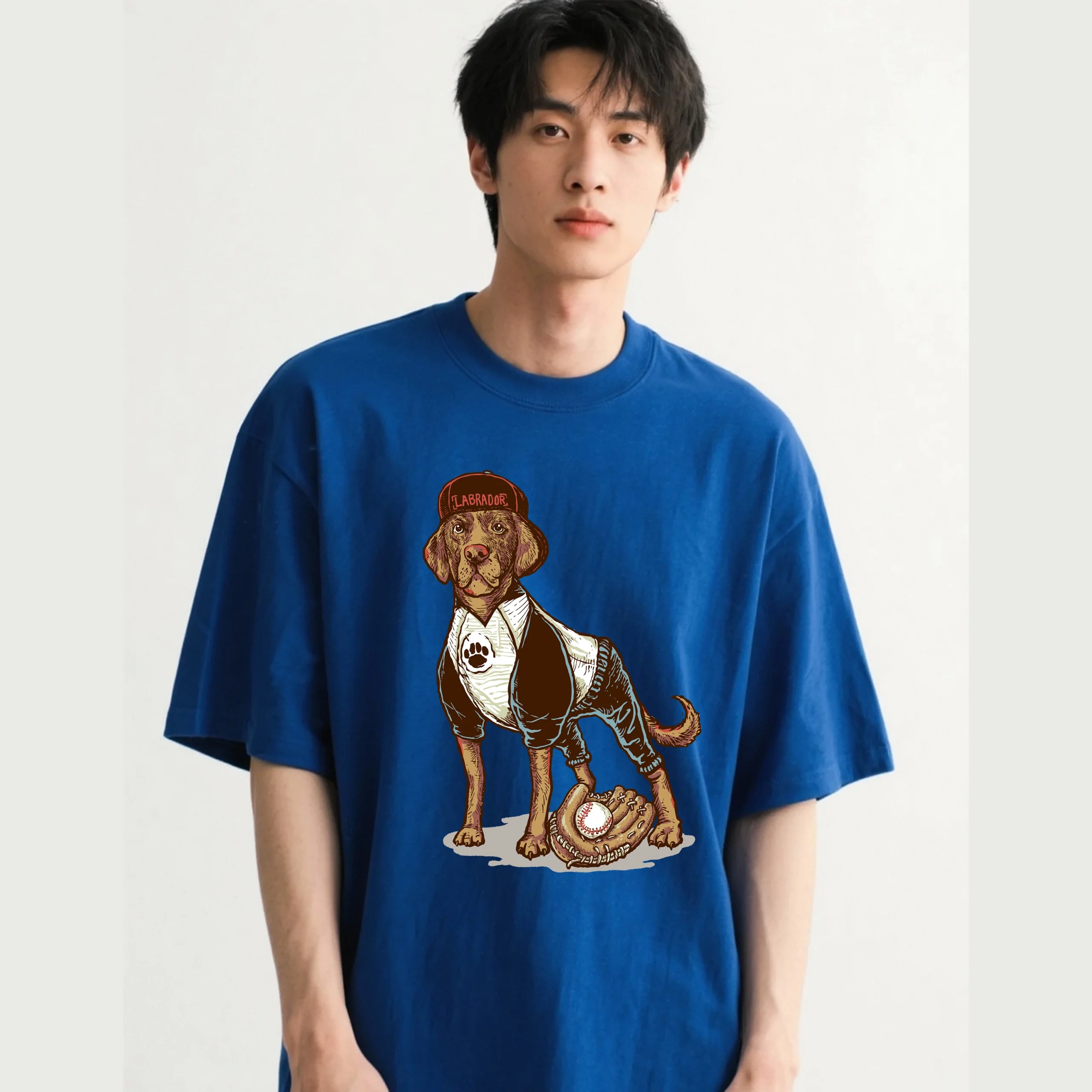 Oversized unisex t-shirt featuring a cartoon Labrador dog playing baseball printed on the front.