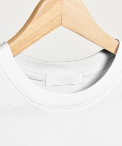 Close-up view of the neck pattern on a white oversized T-shirt.
