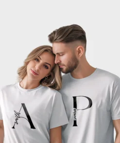 Couple wearing personalized matching white t-shirts with custom names printed on premium cotton fabric, ideal for pre-wedding photoshoots and anniversary gifting.