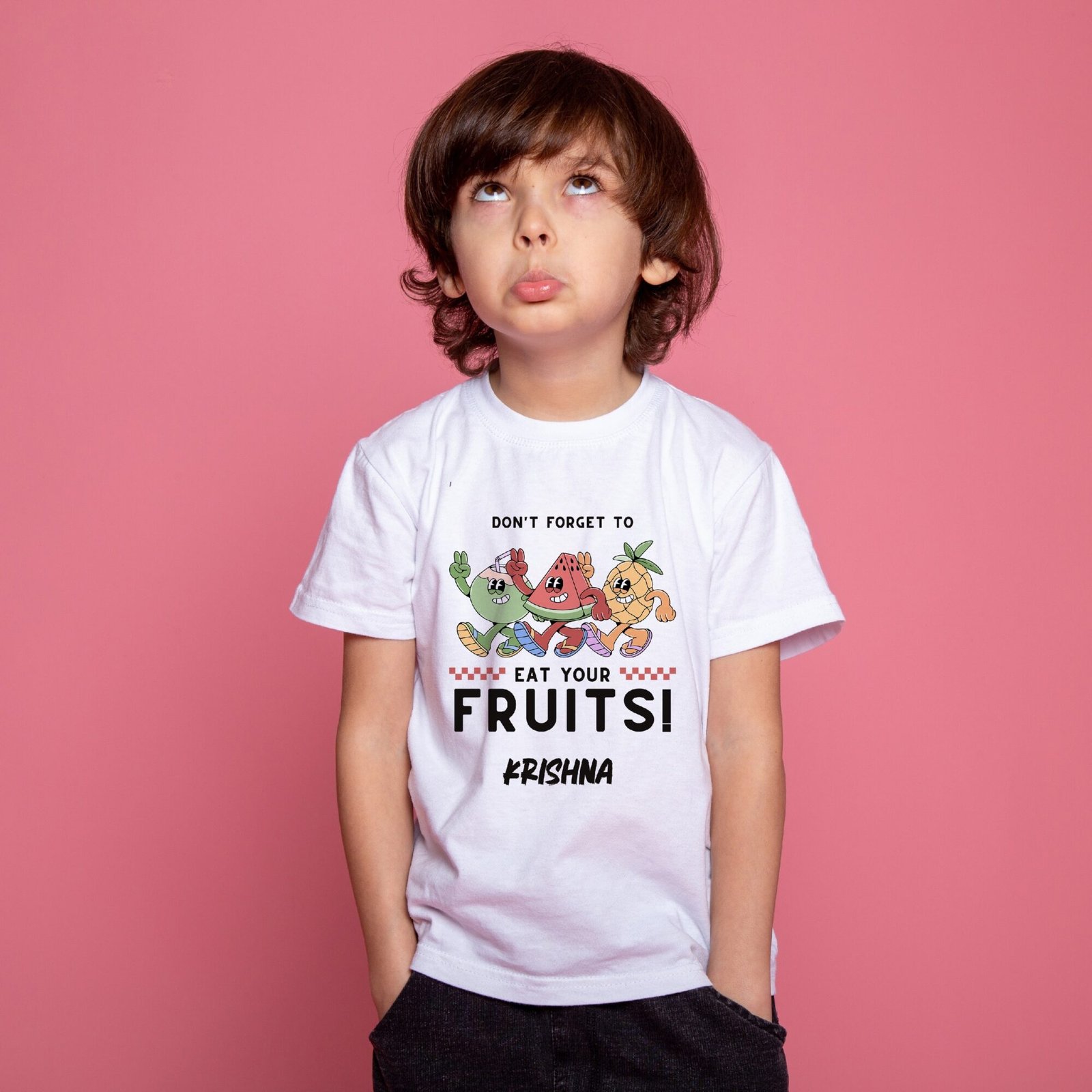 Child wearing a white personalized kids T-shirt with a custom name and "Don't Forget to Eat Your Fruits" colorful fruit design.