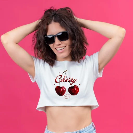 Women wearing a white crop top with cherry print design