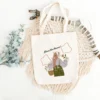 Premium canvas tote bag with zipper and "Bloom Like Flowers" floral design – product photo